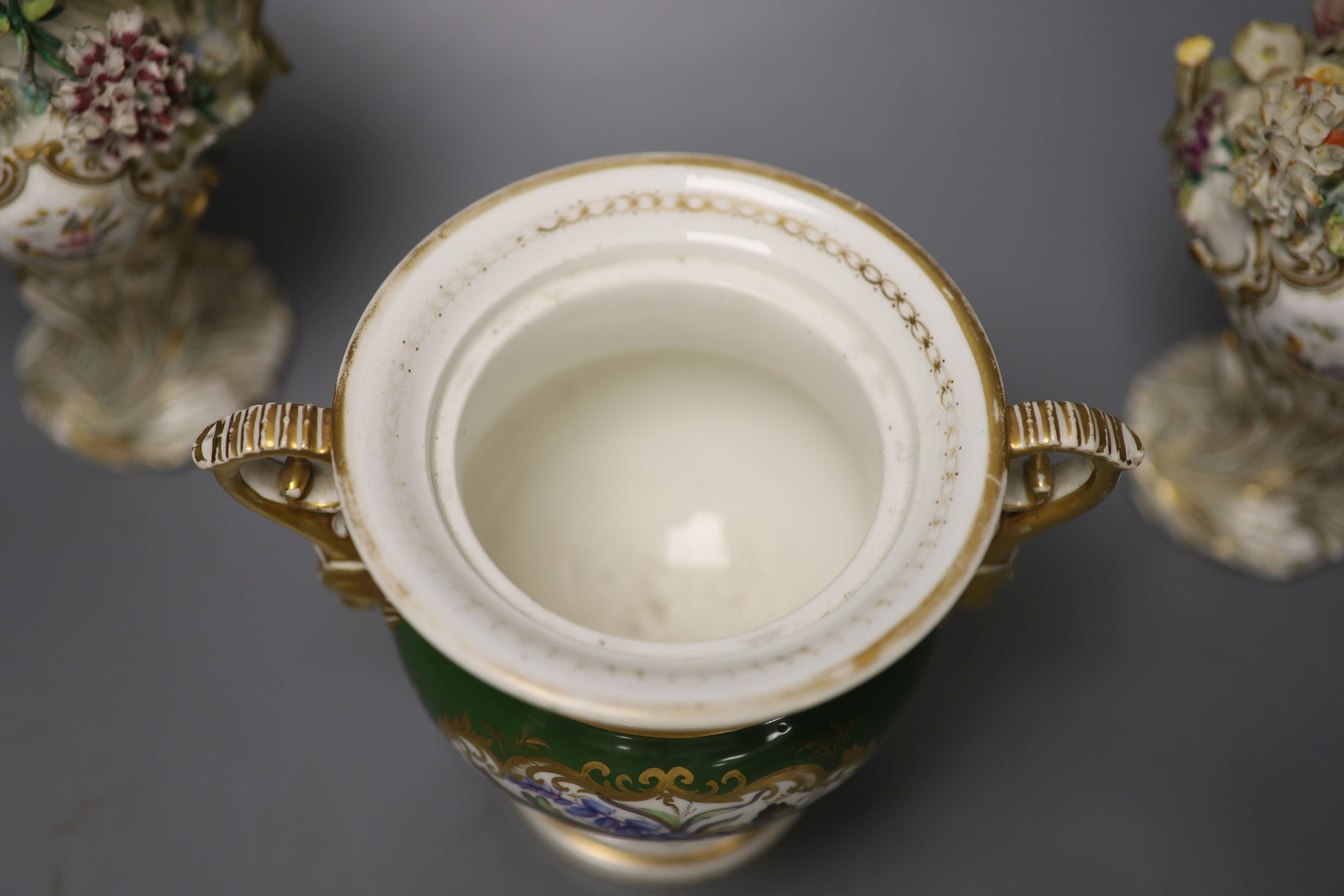 An English porcelain two handled green ground vase and a pair of floral encrusted vases, 20cm